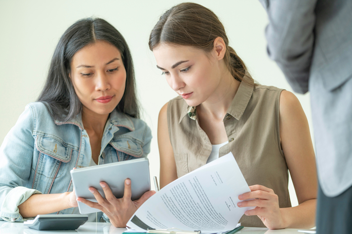 Couple reviewing mortgage paperwork for VA streamline refinance guidance
