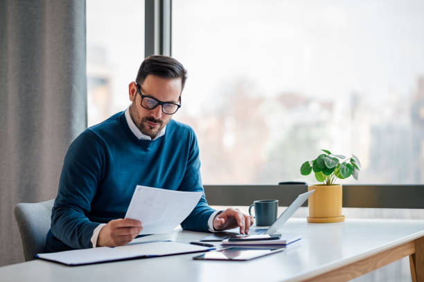 Self-employed borrower reviewing bank statements for a mortgage loan