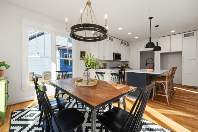 Bright, modern kitchen and dining area with stylish furnishings and abundant natural light.